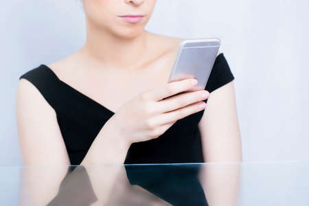 Woman typing on her cell phoneの写真素材