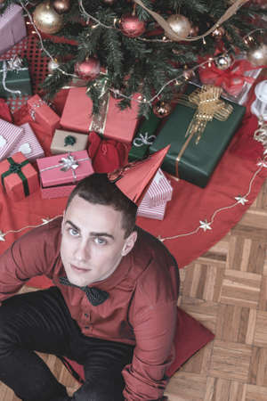 Vintage shot of a man underneath the Christmas tree