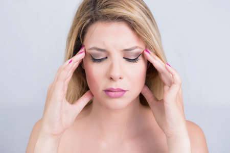 Blonde woman having a headache