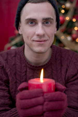 Boy holding a Christmas candle, smilingの写真素材