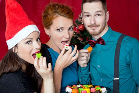 Happy three friends celebrating Christmasの写真素材