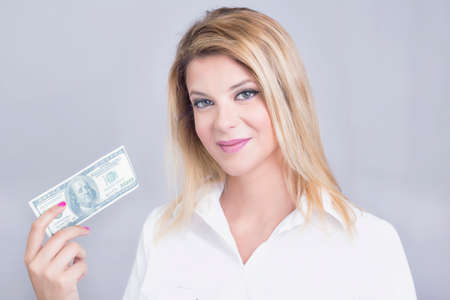 Blonde woman holding dollar billsの写真素材