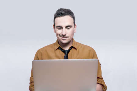 Man smiling to his lap top