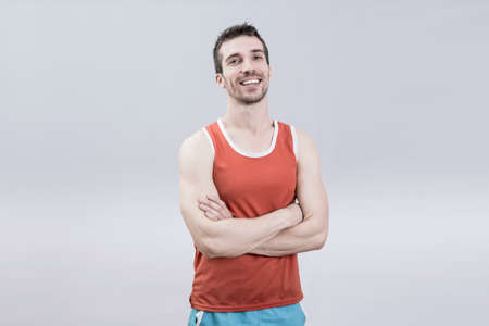Healthy sportsman smiling in studio