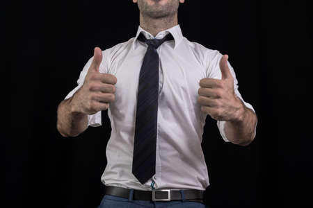 Businessman holding his thumbs upの写真素材