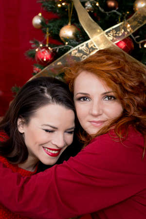 Two girls hugging for Christmasの写真素材
