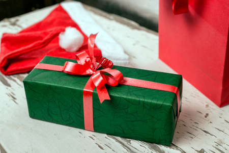Green Christmas present and red ribbonの写真素材