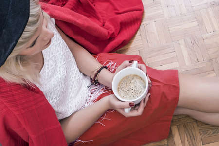 Hipster woman holding a cup of coffeeの写真素材