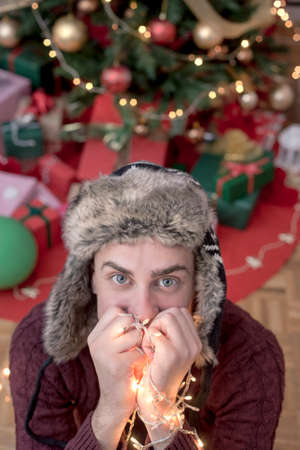 Man holding Christmas lightsの写真素材
