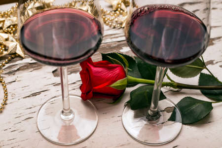 Wine glasses and a red roseの写真素材