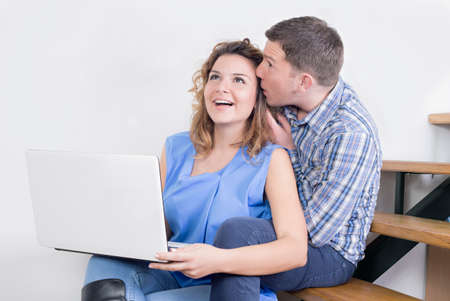 Happy couple and a lap topの写真素材
