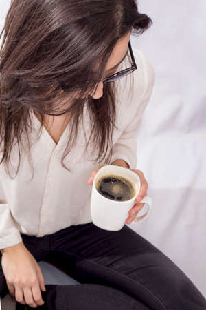 Hipster woman holding a coffee mugの写真素材