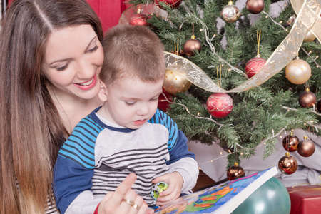 Mother and child reading on Christmasの写真素材