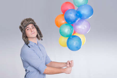 Boy holding balloonsの写真素材