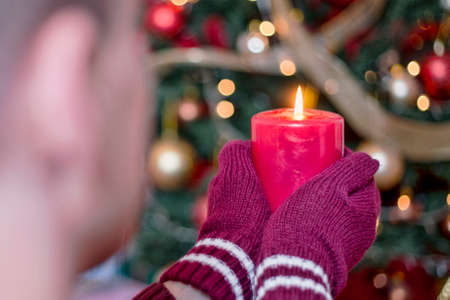 Man holding a red candle on Christmasの写真素材