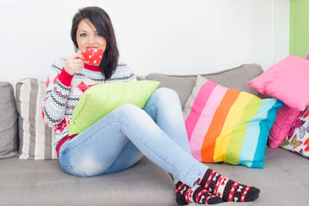 Girl drinking coffee indoorsの写真素材