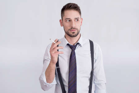 Businessman holding a cigaretteの写真素材