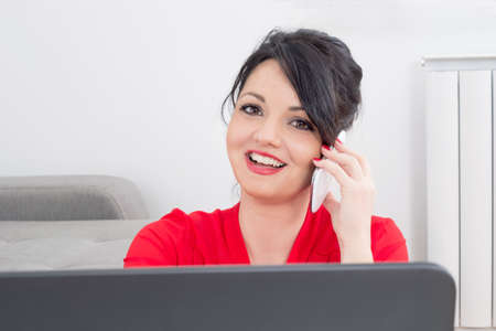 Happy business woman on a phoneの写真素材