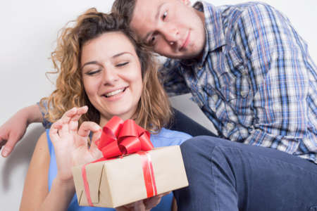 Valentines couple unwrapping a giftの写真素材