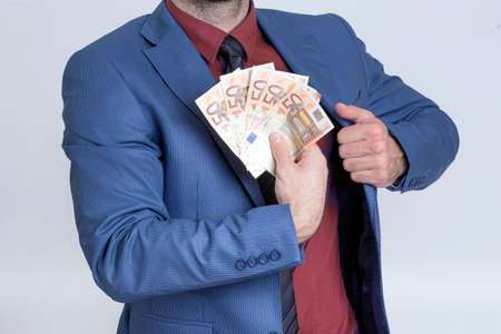 Businessman showing euro billsの写真素材