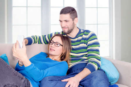 Happy couple and a cell phoneの写真素材