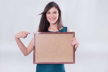 Business girl pointing at a wooden boardの写真素材