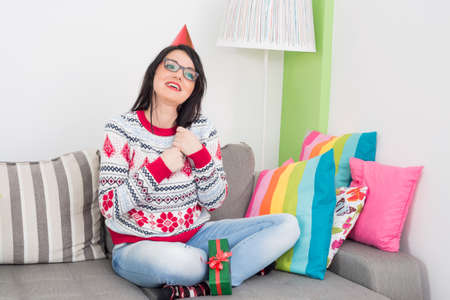 Happy girl in living roomの写真素材