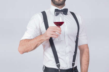 Man making a toast with a glass of wineの写真素材