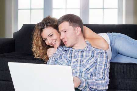 Couple using lap top in the living roomの写真素材