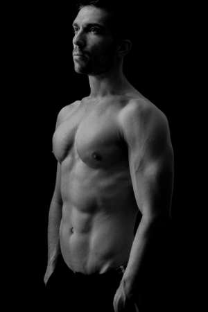 Handsome man posing in darkの写真素材