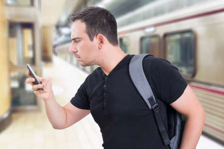 Man in a hurry, using a cell phoneの写真素材