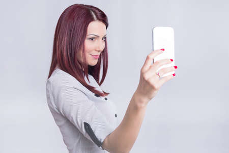 Redhead girl taking a selfieの写真素材