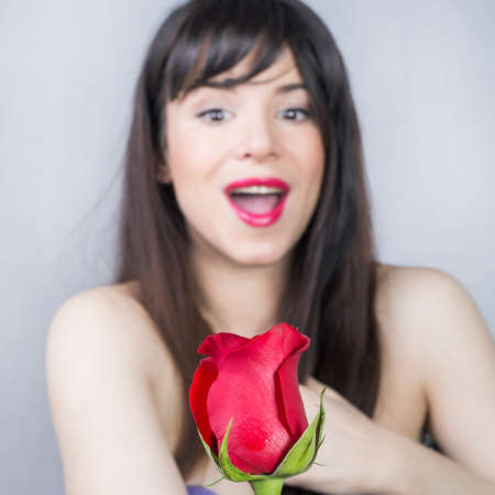Surprised girl and a roseの写真素材