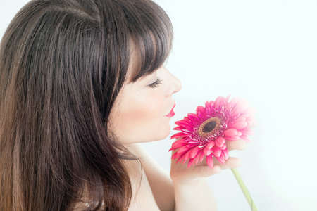 Beauty portrait of a girl with a flowerの写真素材