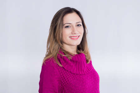 Brunette woman in a pink sweaterの写真素材