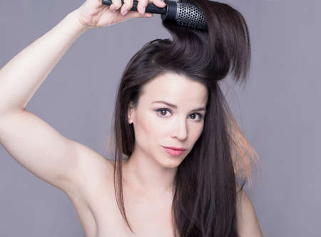 Girl brushing her hairの写真素材