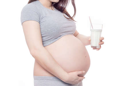 Pregnant woman belly and milkの写真素材