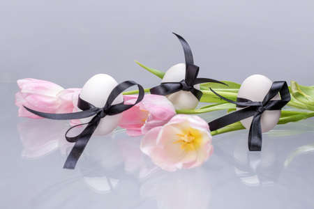 White Easter eggs and tulipsの写真素材
