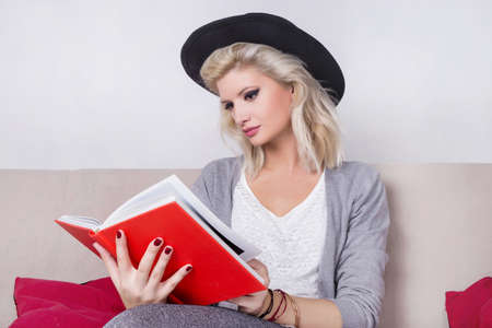 Hipster woman reading a red bookの写真素材
