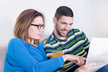 Couple reading newspaperの写真素材