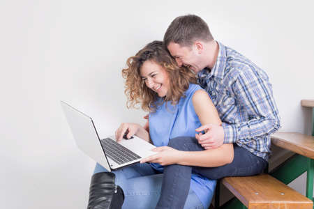 Happy couple using a laptopの写真素材