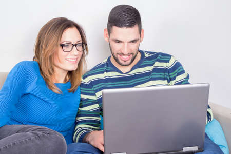 Couple using a laptopの写真素材