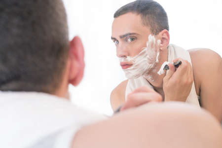 Man shaving in a mirrorの写真素材