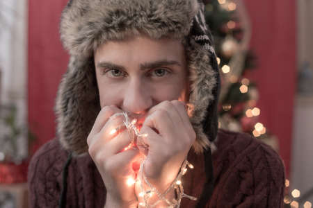 Man holding Christmas lightsの写真素材