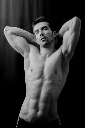 Sexy man posing in black and whiteの写真素材