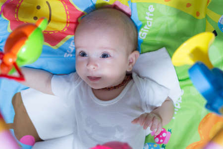Baby laying in a cribの写真素材