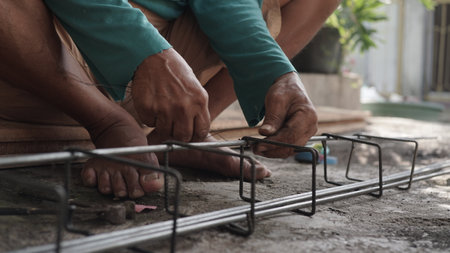 Close-up of the hands of a man working on a construction siteの写真素材