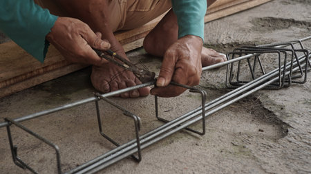Worker working on construction site, closeup of hands and toolsの写真素材