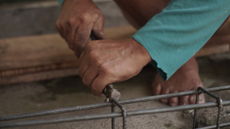 Close-up of a man working on a building construction site.の写真素材