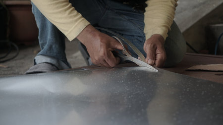 Close-up of a person cutting a piece of metal.の写真素材